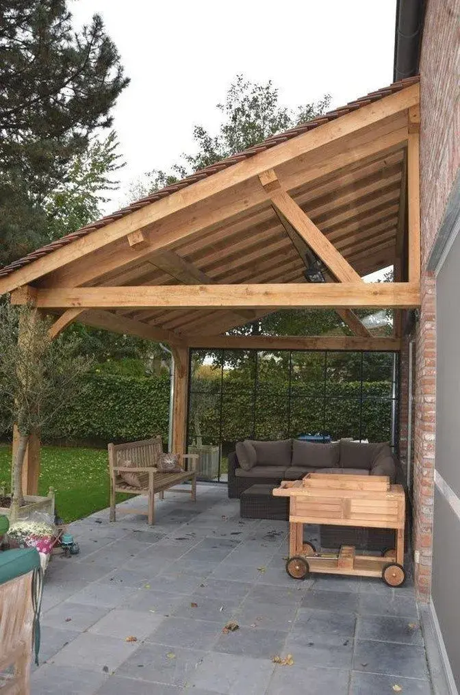 Dřevěná pergola s pohovkou na zahradním terasu.